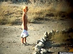 Suntanned nudists filmed as they have fun on a beach