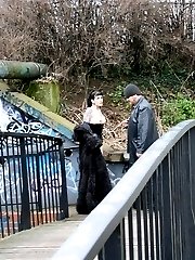 Hot gothic slut treated as a dog in a public bridge