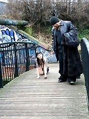Hot gothic slut treated as a dog in a public bridge