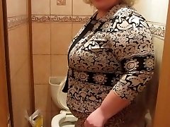 Mature woman with a hairy by a cootchie, pissing in the restroom)