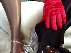 Sensual teasing close up legs and feet in Shining shiny pantyhose and high heels.