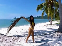 Micro bikini tease by sexy teenager who walks on a beach Micro bikini tease by sexy teenager who walks on a beach