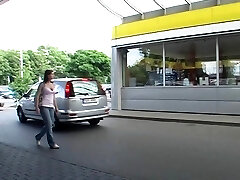 In a public douche she sucks a trouser snake through a gloryhole