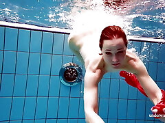 Cute stunner in red sexy open dress swimming Cute stunner in red sexy open dress swimming