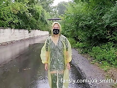 Teen in yellow raincoat demonstrates pussy outdoors in the rain