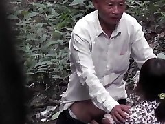 Grandfather With Asian Prostitute In The Woods