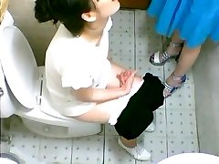 Two cute Asian girls spotted on a toilet cam peeing