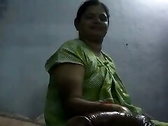 Mature and happy Indian aunty providing oily handjob on cam