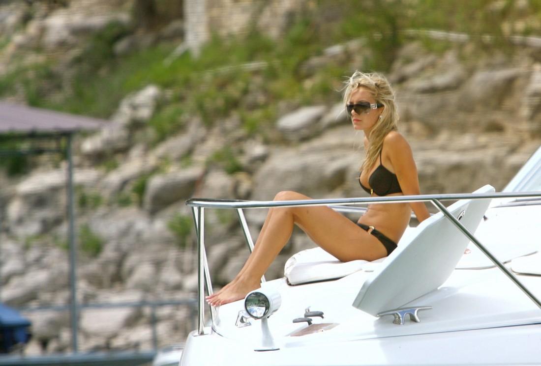 A busty bikini girl undressing on the Rarawa Nudist image