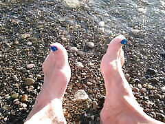 On public beach I sit on the shore wearing shorts and t-shirt and wetting my feet in the sea ...