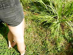 Refreshing & wetting t-shirt and black shorts in hose in the garden...