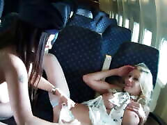 Two lo prende bene attendants on a plane play with their dildos in their tight pussies