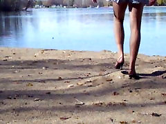 very young asian girl at the lake in hose and heels