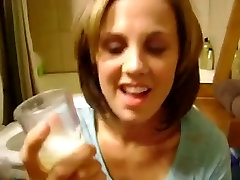 Nice girlfriend is drinking a glass of fresh cum