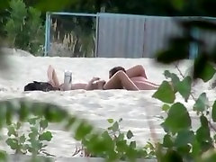 Voyeur tapes 2 nudist couples having bell boobs at the beach