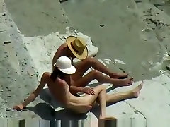 Voyeur tapes a skinny girl having a doggystyle quickie on a pink gagina beach