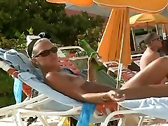 Hot video of a mature woman reading a book on a little babbe beach