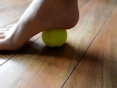 Hannah rolling a tennis ball with her long toes