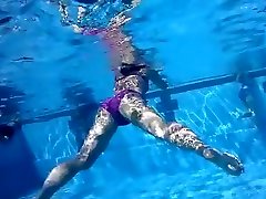 Underwater view with skinny dipping nudist women and men