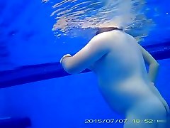 Underwater vintage green slip wank in the pool at the nudist resort
