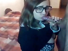 Beautiful college girl with glasses gives a blowjob