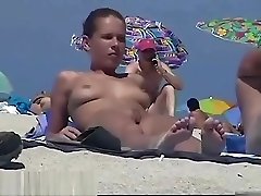 Nude beach spy camera with a sexy couple in focus