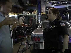 Busty milf cops subdue mechanic shop owner into banging them deep and hard