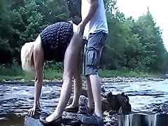 Couple having a sweet asian busty babe quick fuck by the river