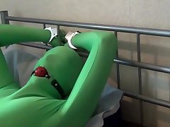 tied up and ball gagged in green man piss street zentai bodysuit