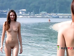 Sensual nude beach girl relaxes outdoors in the sun.
