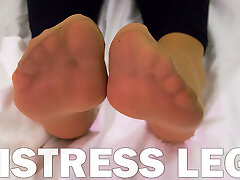 Mistress gym ba in soft nylon socks is resting on the bed
