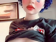 Depressed butterfly goth dame plays with her boobs