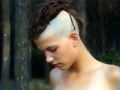 Bony and tall punk girl with two wild men in the forest