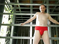 Man on a building site just red briefs pisses and wank his erect uncut cock till he cums