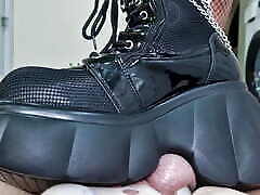 Ballbusting, trampling balls and cock in chastity belt. Dominatrix Nika kicks balls and tramples them in her boots.